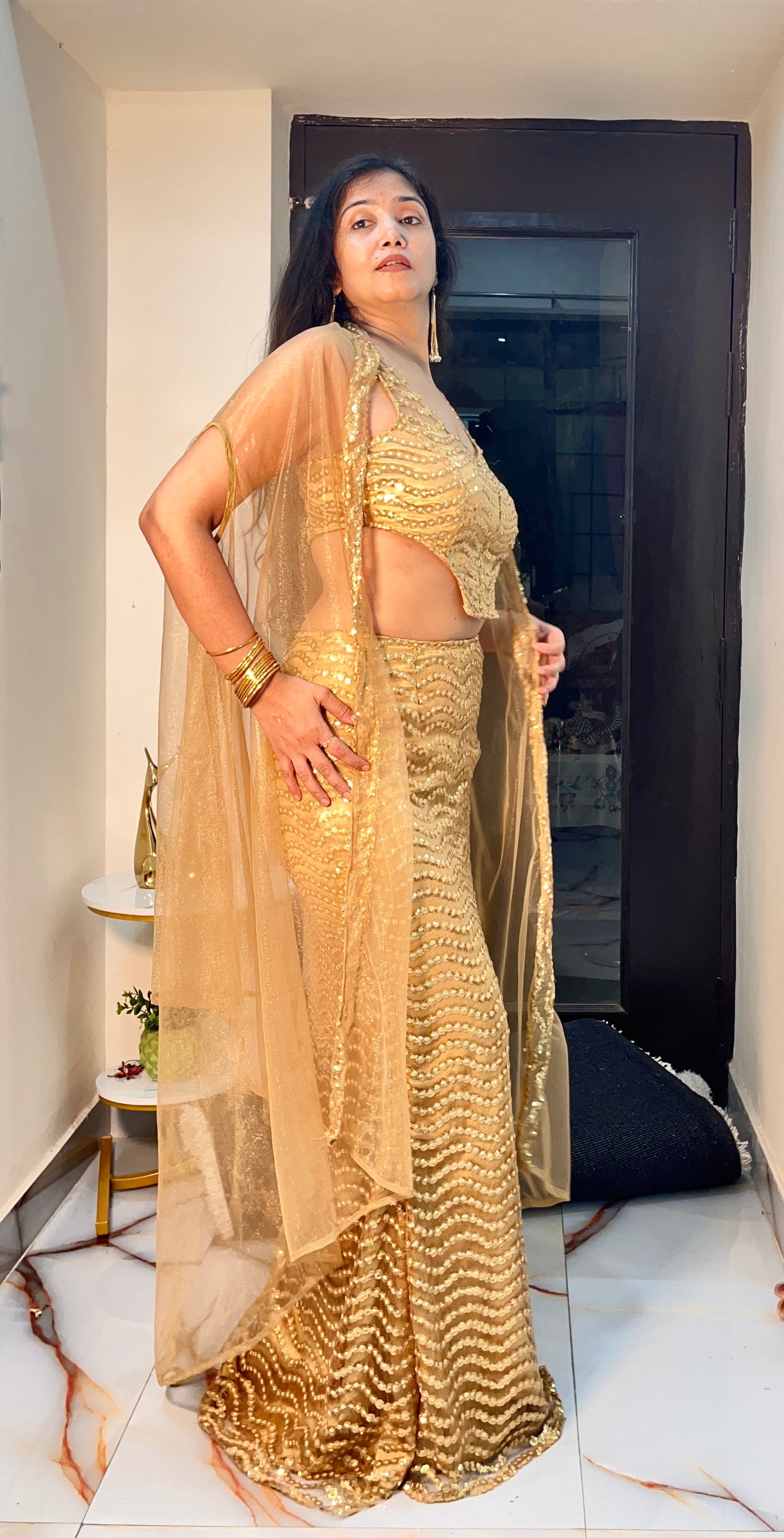 Golden party wear embroidered ensemble in net fabric